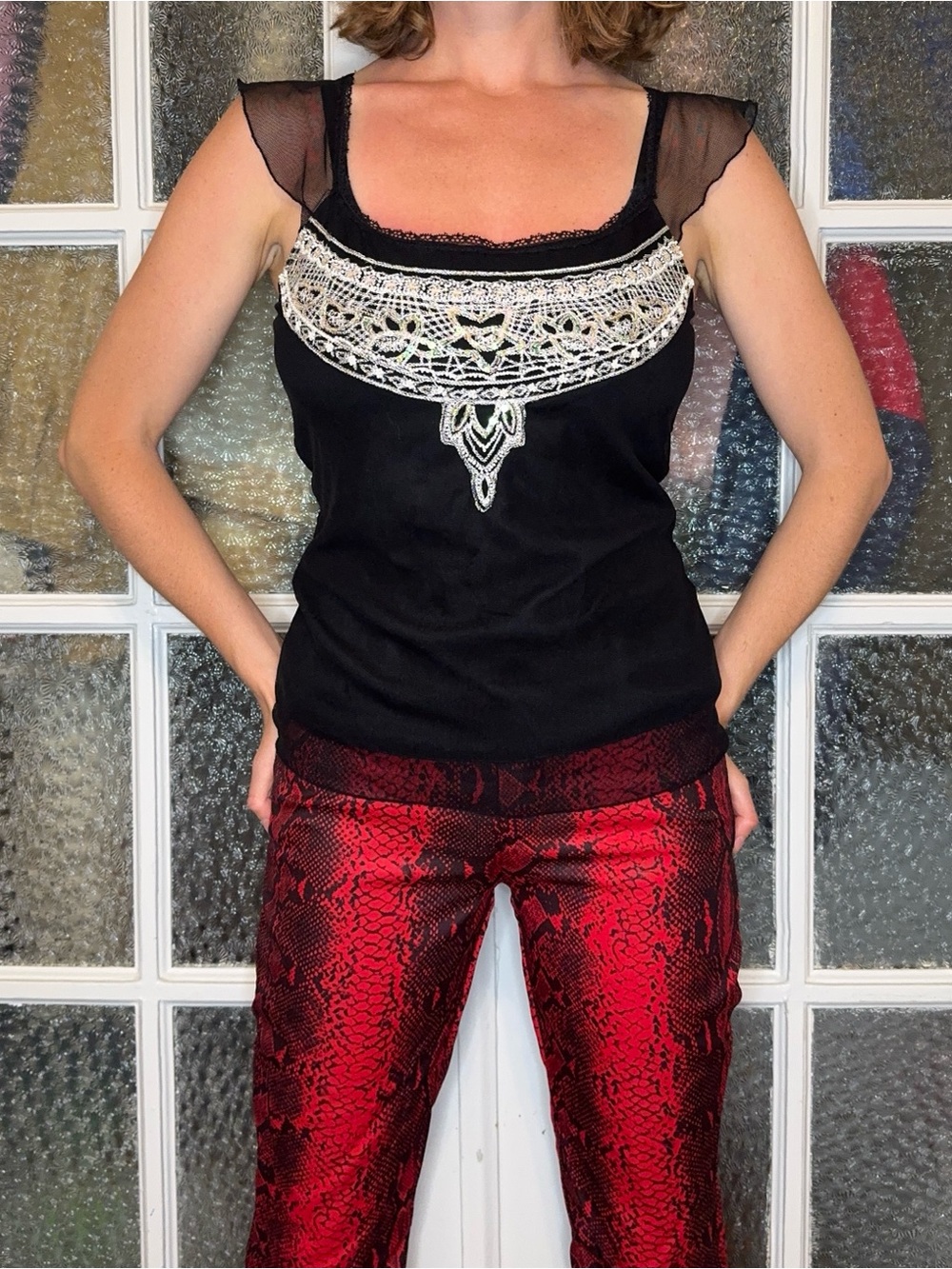 Black top with white beaded detail and mesh overlay